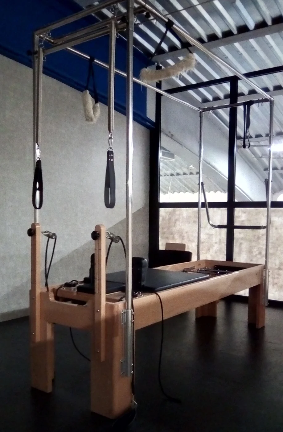 A modern Cadillac / trapeze table, the spring-based apparatus descended from Joseph Pilates' original hospital-bed design